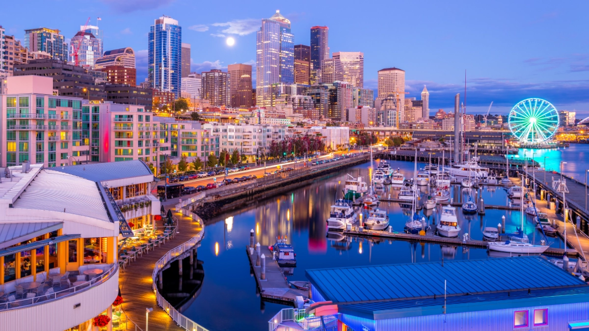 Boats docked in front of the Seattle skyline, with the Space Needle in view.